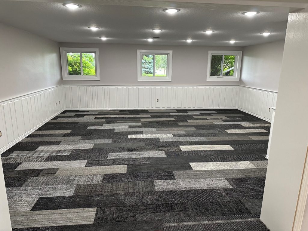 Ashlar or bricks pattern of carpet tiles in room