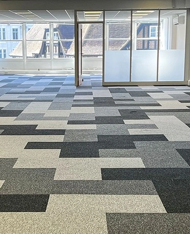 Charcoal carpet tiles open floor design