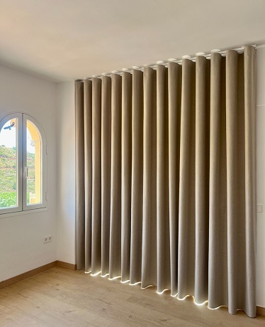 Cream Blackout curtains framing green garden view