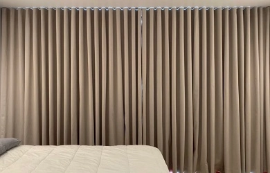Wave-fold beige blackout curtains, cozy bedroom setting