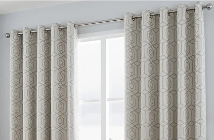 Eveley cream geometric eyelet curtains hanging on metal rod